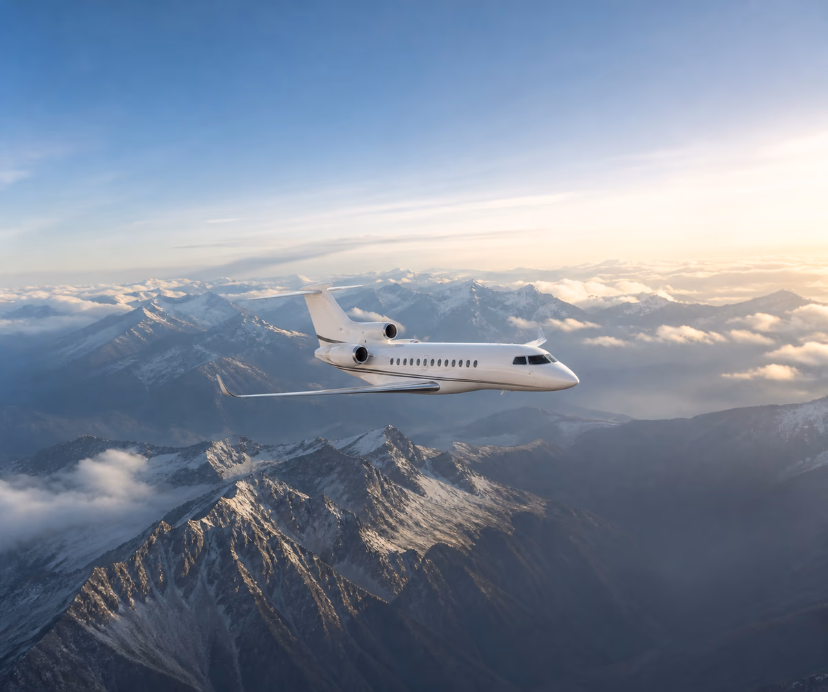 Dassault Falcon 7X flying over snow-covered mountains
